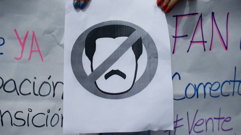 A no symbol over an image  of President  Maduro during  a walk-out against his presidency  in Caracas on January 30th.  Photograph: AP Photo/Ariana Cubillos