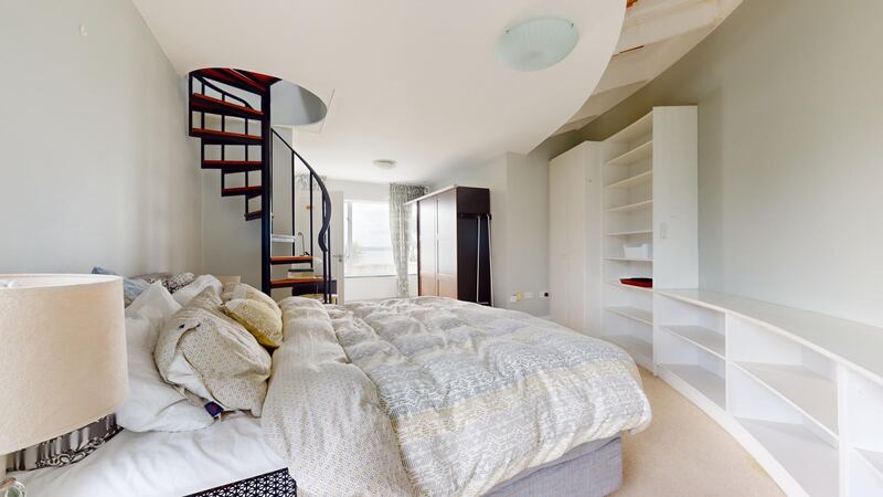 Principal bedroom with curved wall and access to flat roof