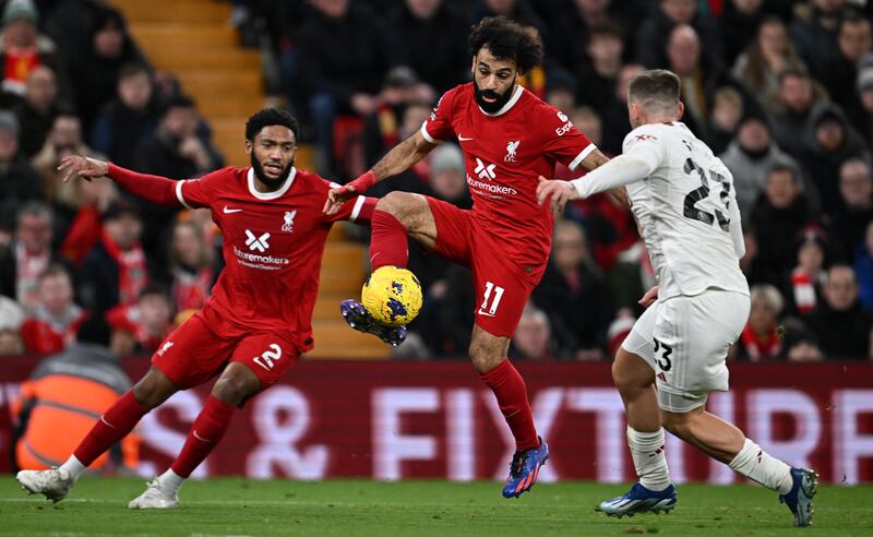 Manchester United's defender Luke Shaw defends against Mohamed Salah. Photograph: Paul Ellis/AFP via Getty