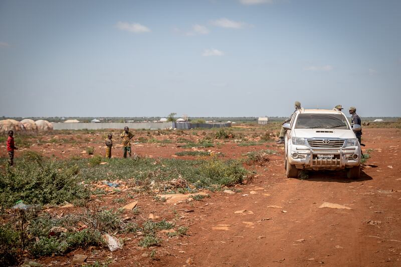 Security guards talk to children in a camp in Baidoa, Somalia, for people displaced by drought and insecurity. Photograph: Sally Hayden