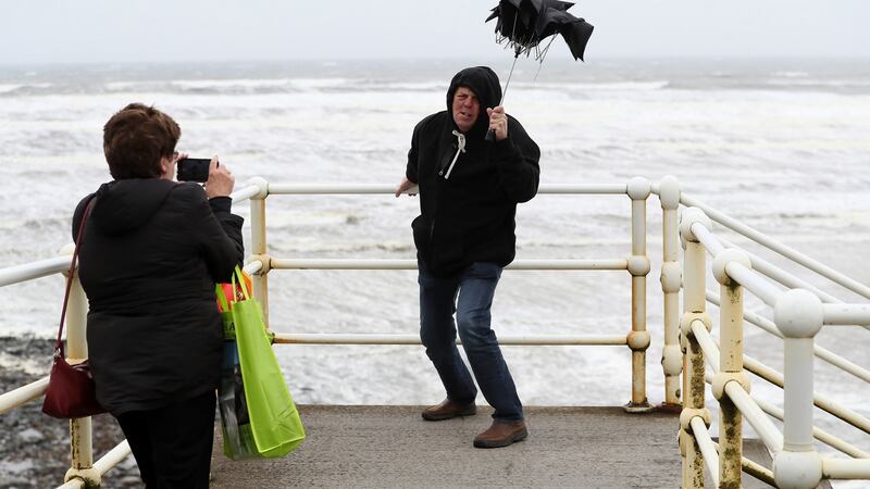 American tourists take photos with a broken umbrella along the sea front in Lahinch, County Clare, on the West Coast of Ireland as Storm Lorenzo made landfall on October 3rd last. Photograph: Brian Lawless/PA Wire