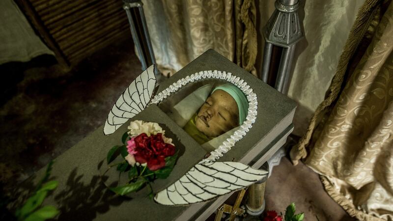 Angel wings made from the food rations box on the coffin of Kenyerber Aquino Merchán (17 months), who died of heart failure caused by severe malnutrition, in San Casimiro, Venezuela. Photograph:  Meridith Kohut/The New York Times