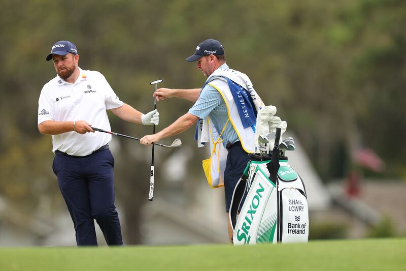 Shane Lowry exchanges clubs with his caddie Darren Reynolds on the fifth green during the first round of the RBC Heritage at Harbour Town Golf Links. Photograph: Andrew Redington/Getty Images