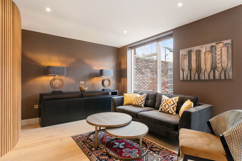 Living area with curved, ribbed wooden wall