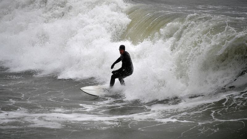 A man surfs in the sea in Bournemouth, England during Storm Dennis on Saturday. Photograph: Neil Hall/EPA