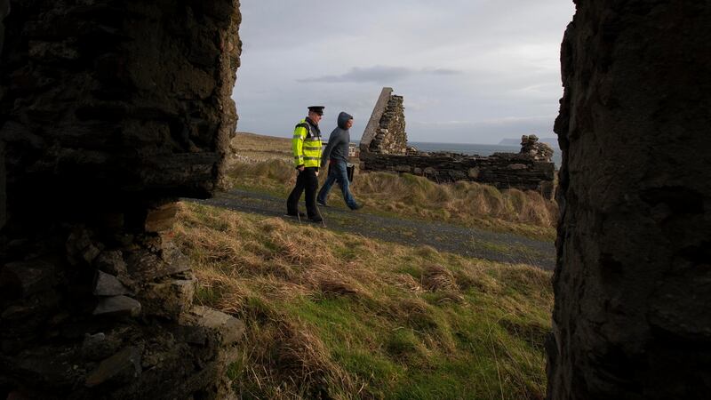 Presiding Officer, James Doohan and Garda Eamonn Gallagher carry Ballot boarrive on Inishbofin Island from an Air Corps helicopter in Co Donegal . Photograph: Colin Keegan, Collins Dublin