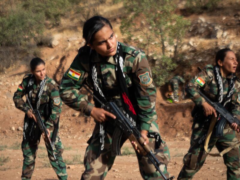 Iranian Kurdish fighters perform drills in their remote mountain hideout in Iraqi Kurdistan. Photograph: Lorraine Mallinder