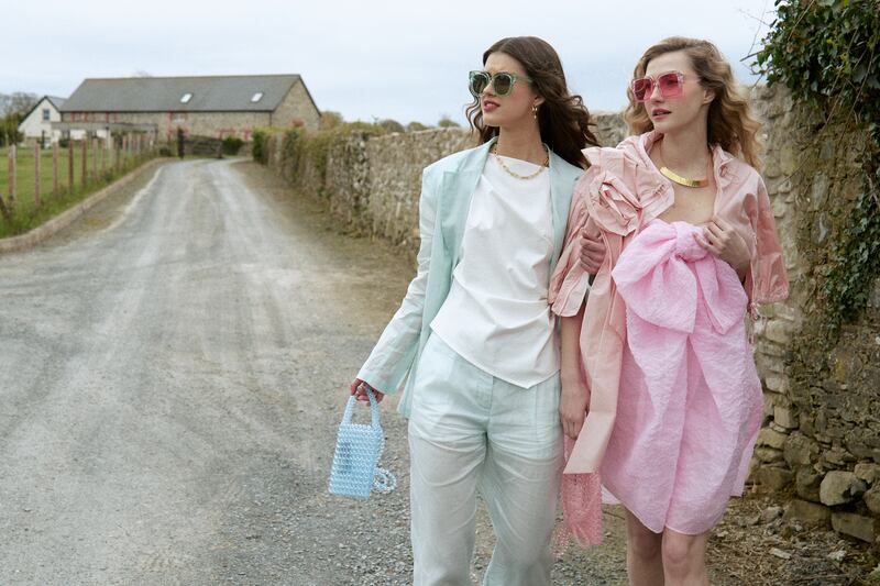 Sheer blazer and pants, €440 and €304, both Beautiful South; beaded bag, €10, Primark; gold earrings and necklace, €18 and €26, both Betty & Biddy.
Pink tulle coat, Simone Rocha, €1,035; pink bow dress, Cecile Bahnsen at Havana, €495; gold necklance and bracelet, €120 and €110, at Beautiful South; pink sunglasses, €5, Primark.