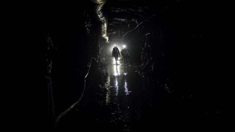 Miners in a puddle-filled tunnel in the Cononish gold mine near Tyndrum. Photograph: Mary Turner/The New York Times