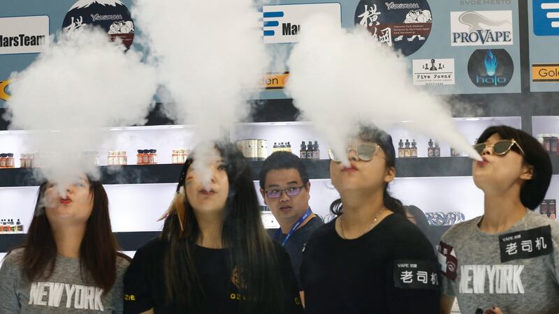 E-cigarette users at a vaping expo in China. E-cigarette vapour contains two previously undiscovered toxic chemicals, according to a new study. File photograph: Rolex Dela Pena/EPA