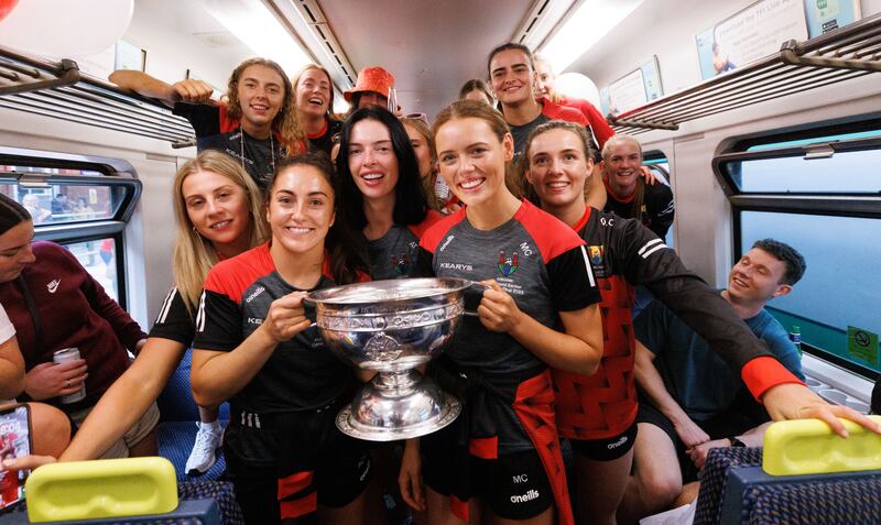 Cork captain Amy O’Connor and vice-captain Meabh Cahalane with the O'Duffy Cup as the victorious Cork squad arrive into Kent Station in Cork. Photograph: James Crombie/Inpho 