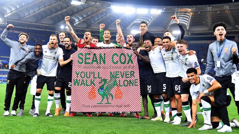 Liverpool players with a banner supporting Sean Cox at the Olimpico stadium in Rome last  May. Photograph: Ettore Ferrari/EPA