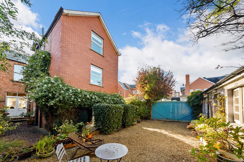 A well-established star jasmine creeper adds drama and beauty to the back garden