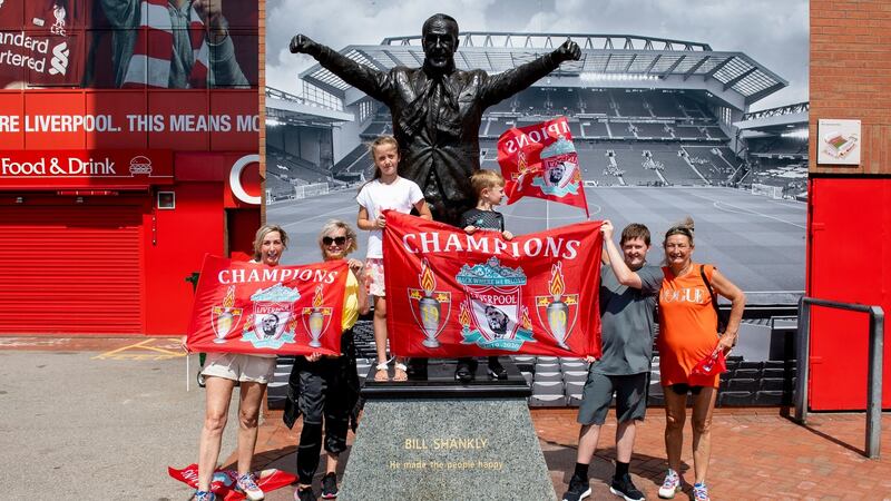 Liverpool  fans pose for a photograph next to Bill Shankly’s  statue at Anfield as they celebrated the club’s Premier League title win. Photograph: Peter Powell/EPA