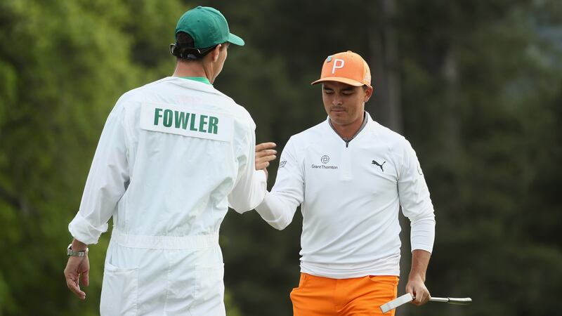 Rickie Fowler celebrates  a birdie with caddie Joseph Skovron on the 18th green during the final round of the 2018 Masters. Photograph: Jamie Squire/Getty Images