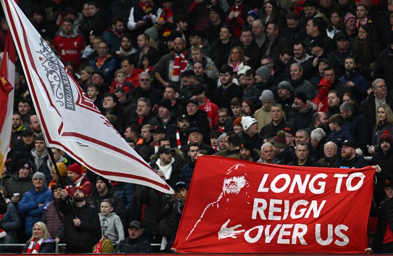 A fan holds a tribute to Liverpool's manager ahead of the English FA Cup fourth round football match between Liverpool and Norwich City at Anfield which the Reds won 5-2. Photograph: Getty Images