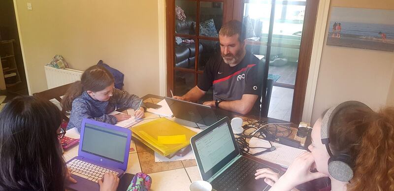 Damian Cullen at the kitchen table with his daughters