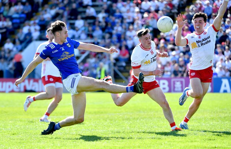 Ruairí Canavan and Conall Devlin of Tyrone fail to stop Brian O'Connell of Cavan scoring a point. Photograph: Inpho