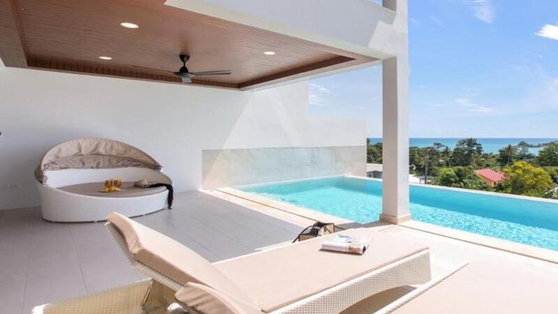 Thailand: this Koh Samui villa has sliding glass doors on to a terrace with a shaded area and infinity swimming pool