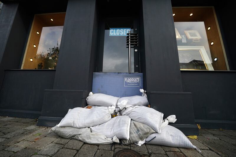 Sandbags and a flood-defence barrier in a shop doorway in Galway city centre. Photograph: Brian Lawless/PA Wire