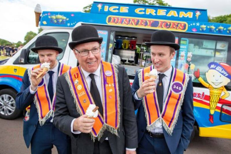 Orange Order members enjoy ice creams as they gather at Stormont in May to mark the hundred years of the formation of Northern Ireland