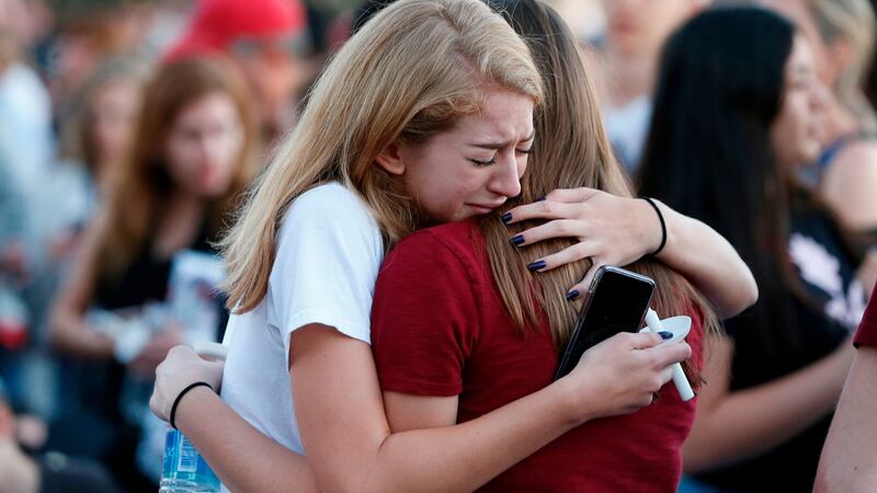 Mourners embrace ahead of a  vigil at the high school on Thursday. Photograph: Rhona Wise/AFP/Getty Images