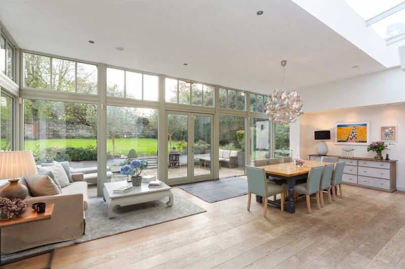 Living/dining area: 'Moving to the back of the house, you can see how the architect made the most of the light coming in from the south, with everything oriented towards the sun as it crosses the sky.' 
