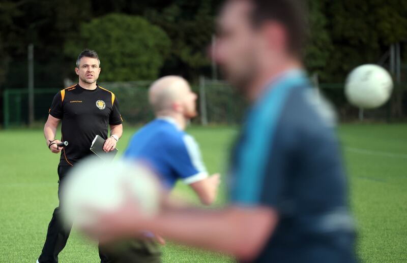 David McGreevy, co-founder and manager of the East Belfast GAA team, with his players during a training session at the Newforge Lane sports complex in Belfast. Photograph: Stephen Davison