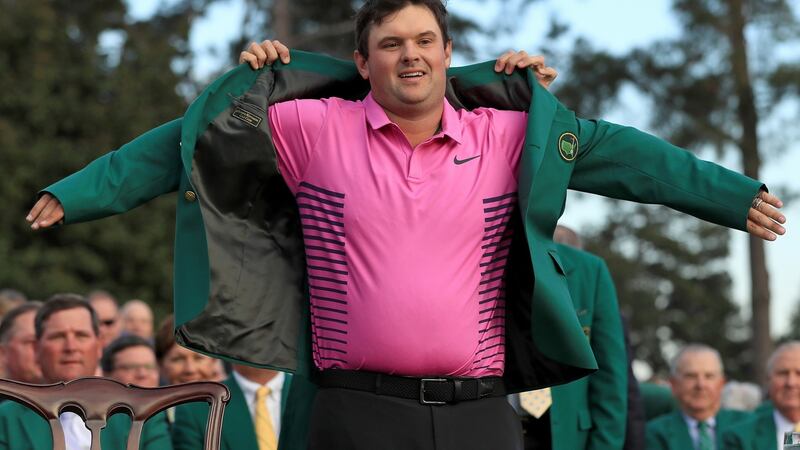 Patrick Reed  is presented with the Green Jacket by Sergio Garcia after his Masters victory in Augusta. Photograph:     Andrew Redington/Getty Images