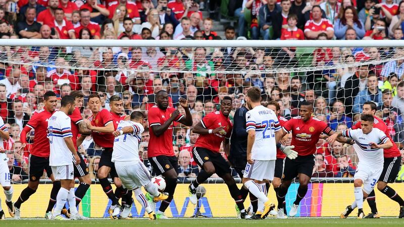 Fabio Quagliarella has his indirect free-kick blocked by a barrage of United players. Photo: Paul Faith/Getty Images