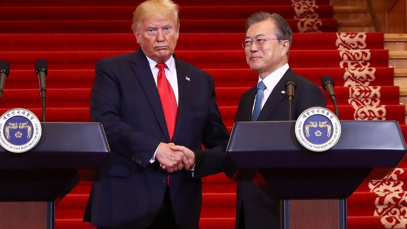 US president Donald Trump shakes hands with South Korean president Moon Jae-in during a joint press conference in Seoul. Photograph: Chung Sung-jun/AFP/Getty Images