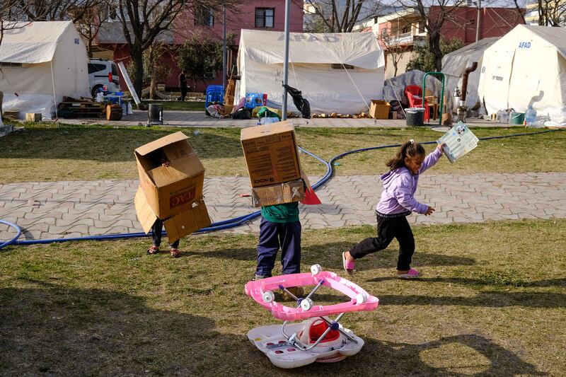 Young earthquake victims enjoy their time playing near their tent in the aftermath of the earthquakes in Nurdagi on Saturday. Photograph: Sedat Suna/EPA