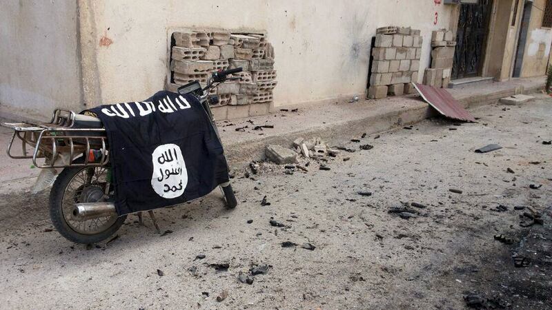 A flag belonging to the Islamic State fighters is seen on a motorbike after forces loyal to Syria’s President Bashar al-Assad recaptured the historic city of Palmyra. Photograph: Reuters