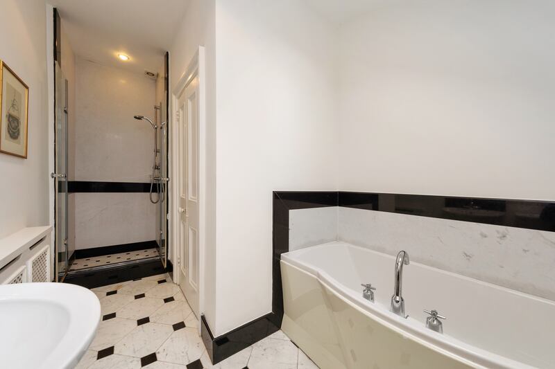 A handsome family bathroom with smart black-and-white tiles. 