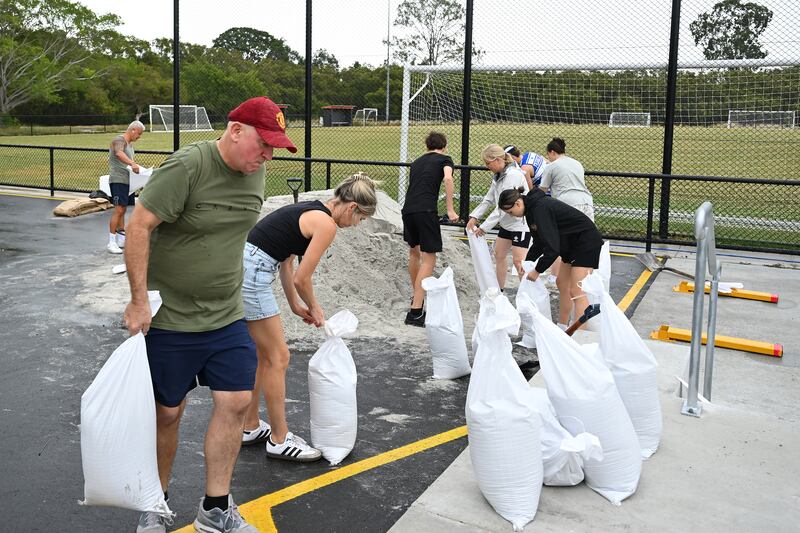 Members of Eastern Suburbs Soccer Club fill sandbags at Heath Park on March 5th, 2025, in Brisbane, Australia. Photograph: Albert Perez/Getty Images