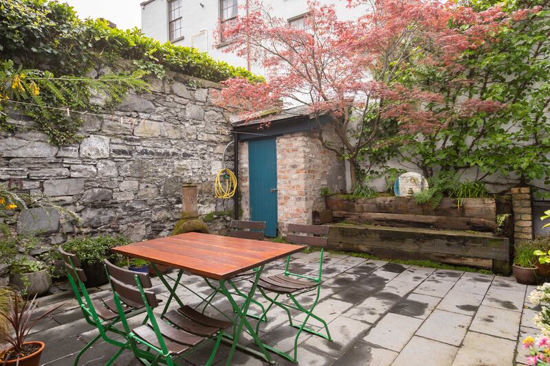 The quiet rear garden is a good spot for dining over the summer.