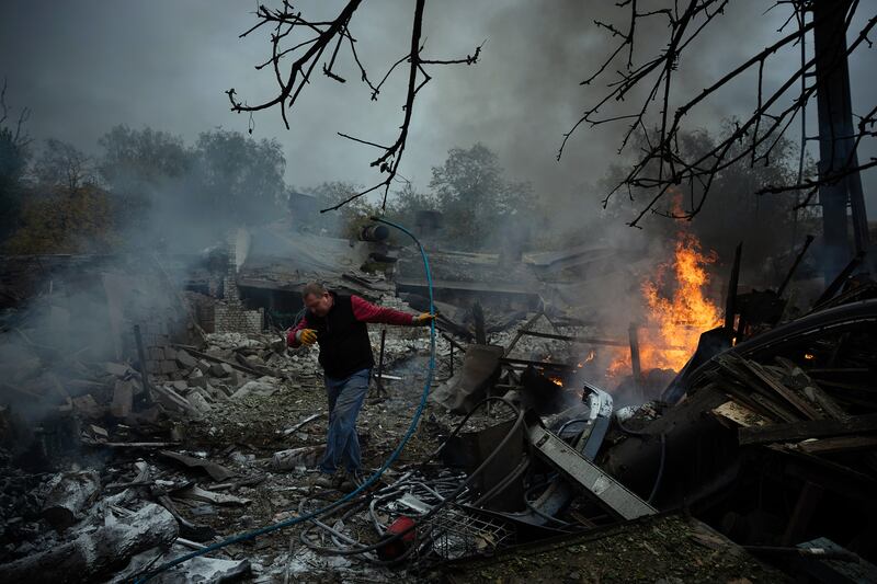 A man makes his way past burning wreckage following a Russian drone attack, which injured several people in the Donetsk region of eastern Ukraine. Photograph: Tyler Hicks/The New York Times
                      