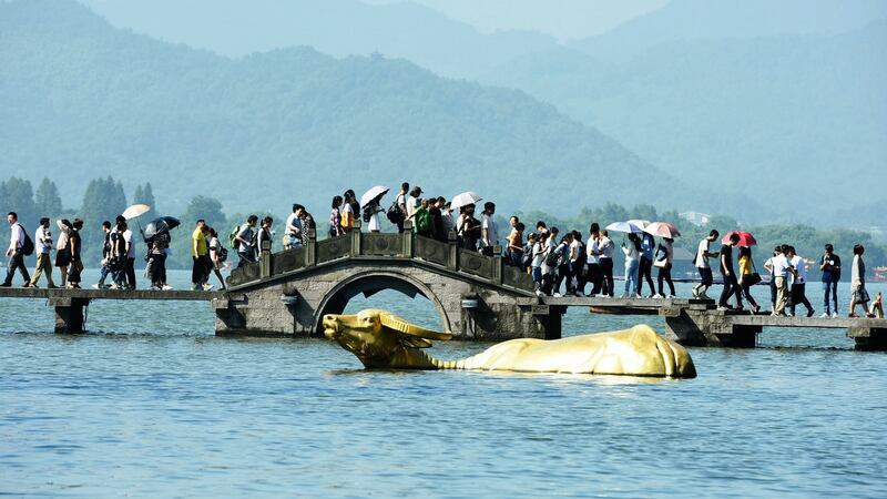 Tourists visit the West Lake the day after National Day in Hangzhou, Zhejiang Province of China. Photograph: VCG/VCG via Getty Images