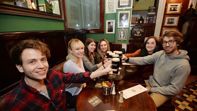 Pierce Bunch, Haley Wells, Bethany Ferraro, Lauren Thalheimer, Alexandra Kononenko, Faison Bunch, enjoy a pint on Good Friday morning. Photograph: Alan Betson/ The Irish Times