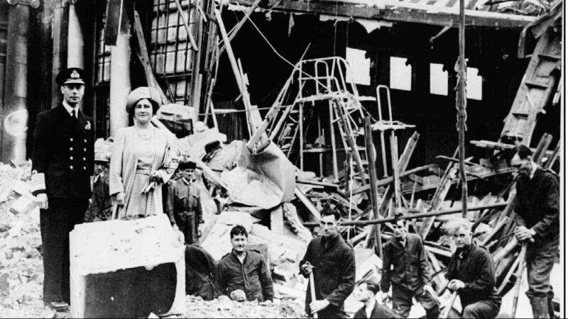 King George VI and Queen Elizabeth stand amid the wreckage caused by German bombs in September 1940.
