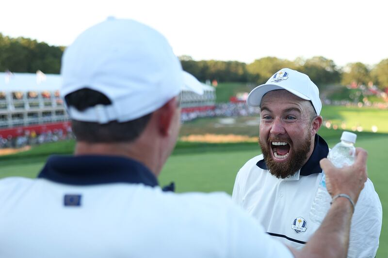 Shane Lowry and Rory McIlroy celebrate victory on the 18th green after defeating Team United States 15-13. Photograph: Richard Heathcote/Getty Images