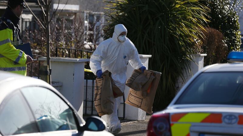 Garda technical bureau carry evidence from the scene at Aubrey Grove Shankill, Co Dublin. Photograph: Collins