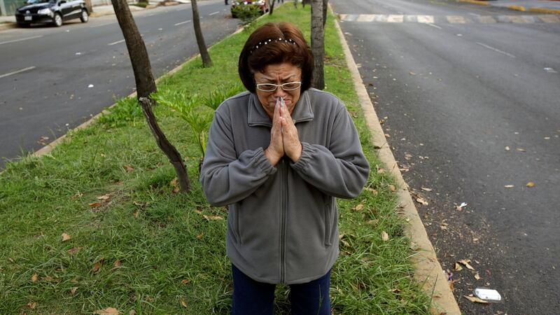 A woman prays after a tremor was felt in Mexico City, Mexico. Photograph: Jose Luis Gonzalez/Reuters