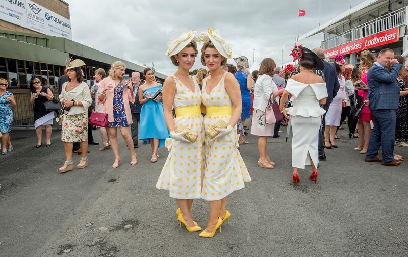 Twins Daninia and Dawn Knight from Portarlington, Co. Laois photographed during Ladies Day at the Galway Races. Photograph: Brenda Fitzsimons / The Irish Times