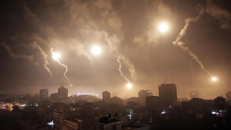 Dazzling: Israeli forces’ flares light up the sky during an overnight bombardment. Photograph: Khalil Hamra/AP