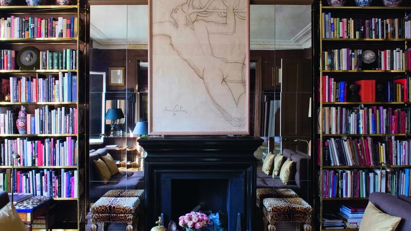 Paolo Moschino & Philip Vergeylen have stacked their coffee table books within a pair of brass escaliers that flank the fireplace in the drawing room of their London apartment. Photograph: Clive Nichols