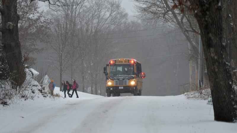 Children dropped off by a school bus as snow falls in Norfolk, Massachusetts. Photograph: Matt Campbell/EPA