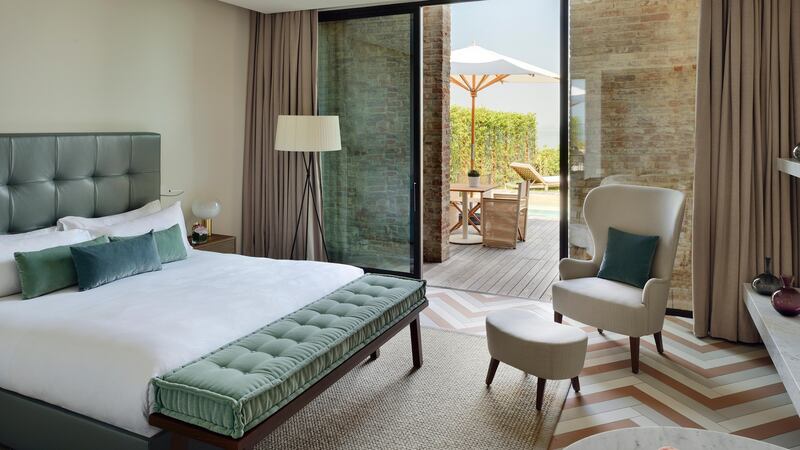 The new JW Marriott resort features a private garden, swimming pool and spectacular views over the sinking city’s skyline