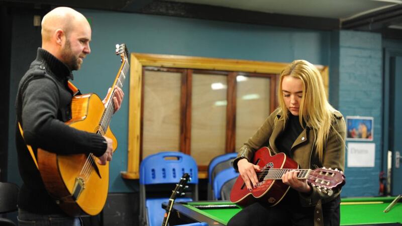 Jessica Kirwan (17)  learns guitar from Brendan Maher at the Swan Youth Services in Ballybough, Dublin. Photograph: Aidan Crawley