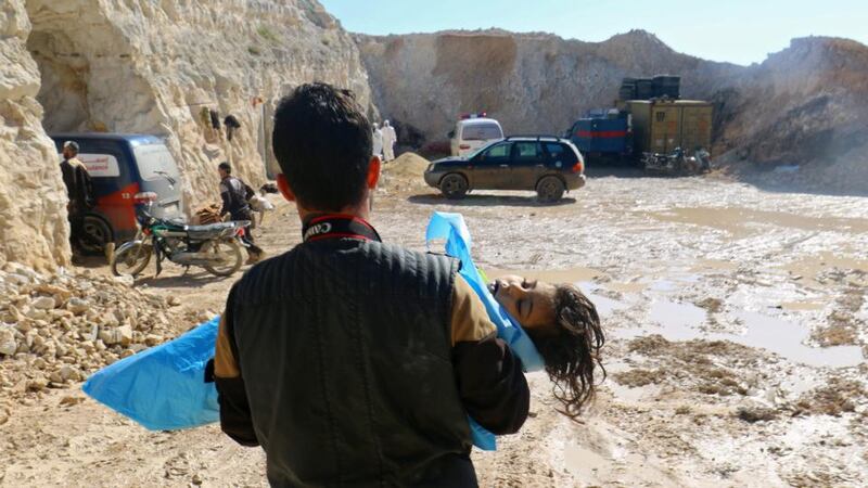 Syrian gas attack: a man carries the body of a dead child on Tuesday. Photograph: Ammar Abdullah/Reuters